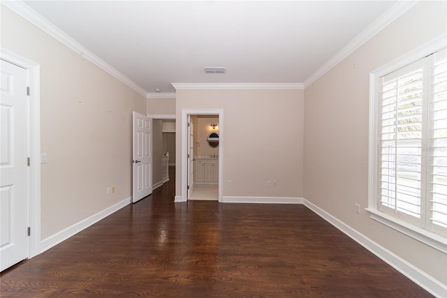 empty room featuring crown molding and dark hardwood / wood-style flooring