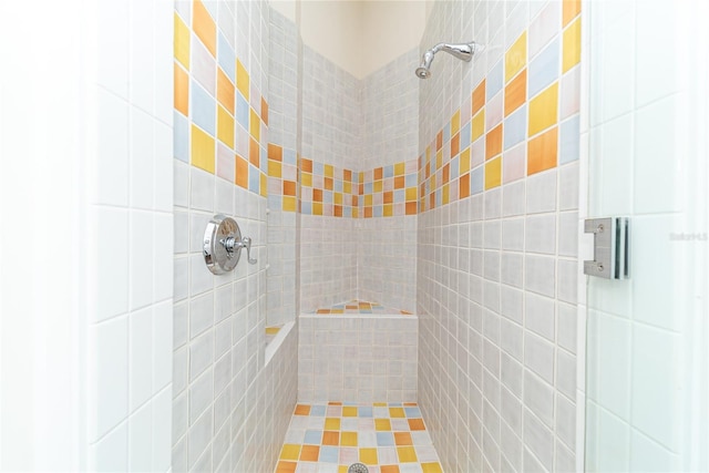 bathroom with tiled shower