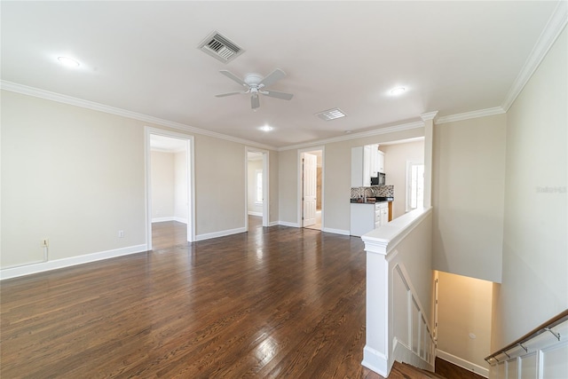 spare room with crown molding, dark hardwood / wood-style floors, and ceiling fan