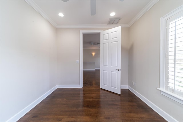 empty room with ceiling fan, dark wood-type flooring, and crown molding