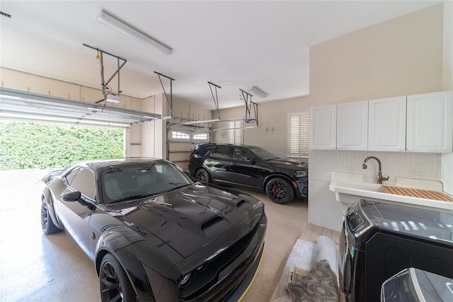 garage featuring washer / dryer and a garage door opener