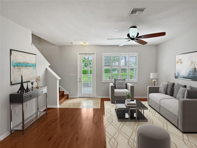 living room featuring ceiling fan and light wood-type flooring