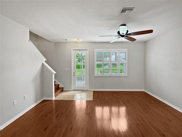 empty room featuring ceiling fan and light hardwood / wood-style flooring