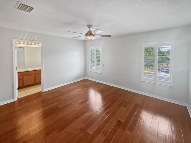 unfurnished room featuring sink, ceiling fan, and light hardwood / wood-style flooring