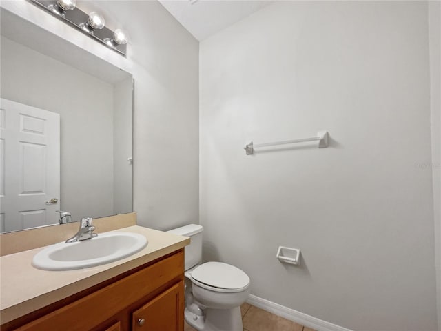 bathroom featuring toilet, tile floors, and vanity with extensive cabinet space