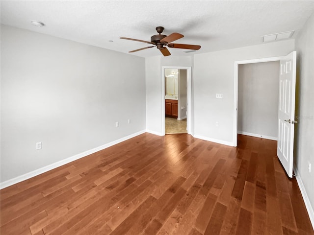 empty room featuring dark wood-type flooring and ceiling fan