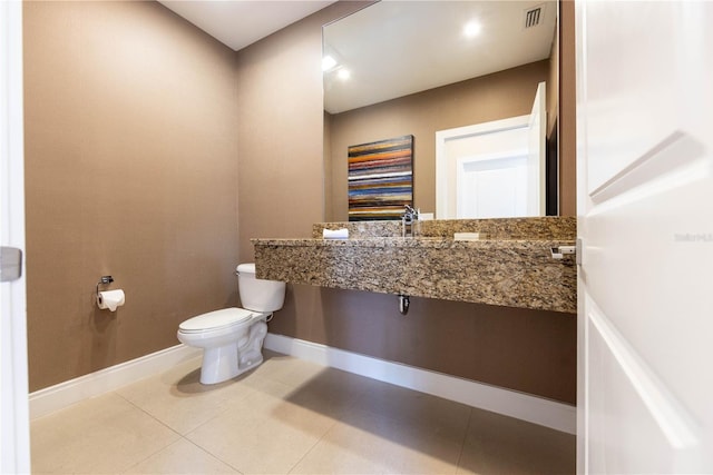 bathroom featuring tile floors and toilet