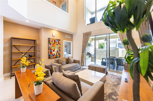 living room with tile floors and a high ceiling