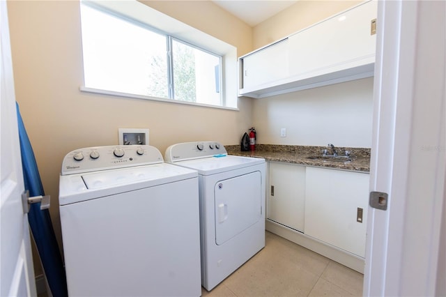 laundry area with sink, hookup for a washing machine, light tile floors, and washing machine and clothes dryer