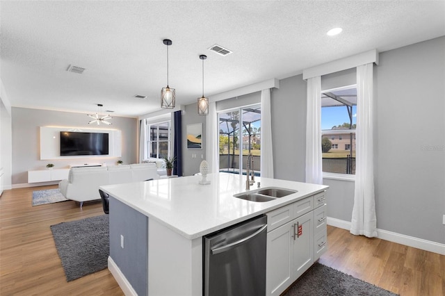 kitchen with sink, a center island with sink, light hardwood / wood-style floors, and dishwasher