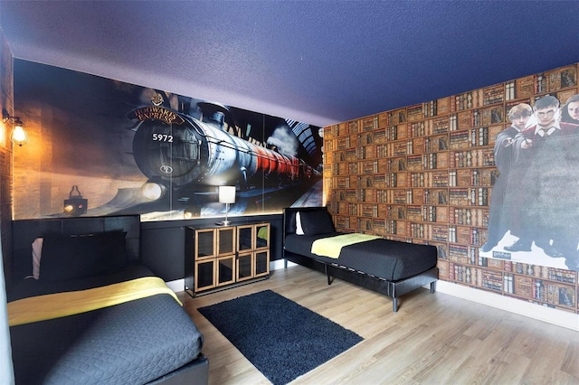 bedroom featuring hardwood / wood-style floors and a textured ceiling