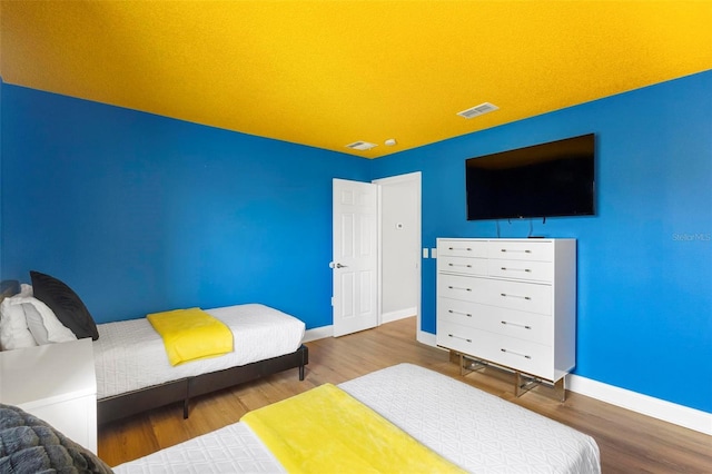 bedroom with wood-type flooring