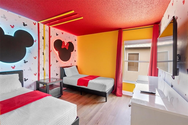 bedroom with hardwood / wood-style flooring and a textured ceiling