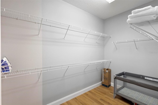 walk in closet featuring light hardwood / wood-style flooring