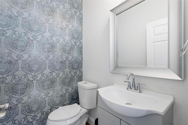 bathroom featuring vanity and toilet