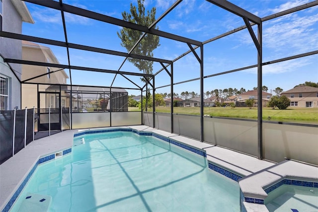 view of pool with a lanai and an in ground hot tub