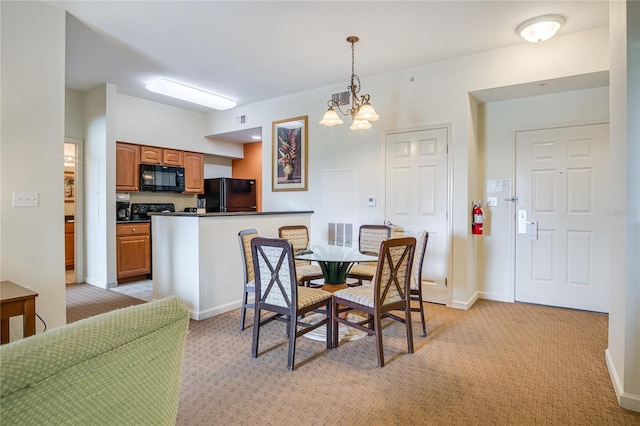 dining room with light carpet and a notable chandelier