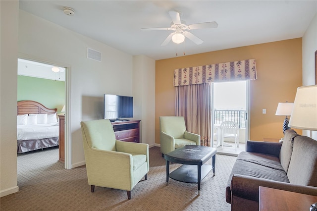 living room featuring light carpet and ceiling fan