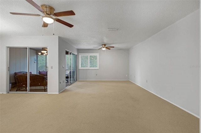 unfurnished living room featuring a textured ceiling, light colored carpet, and ceiling fan