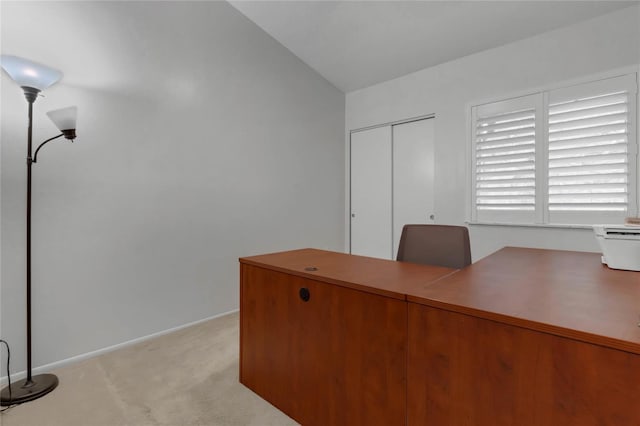 unfurnished office with light carpet and lofted ceiling