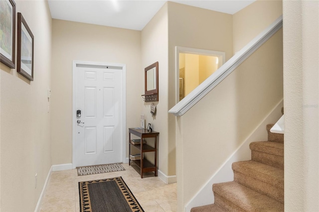 foyer entrance with light tile flooring