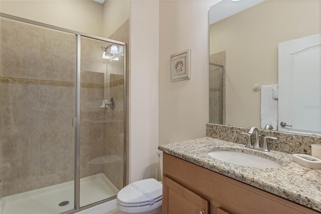 bathroom with vanity, toilet, and walk in shower