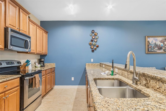 kitchen featuring light tile floors, light stone countertops, sink, and stainless steel appliances