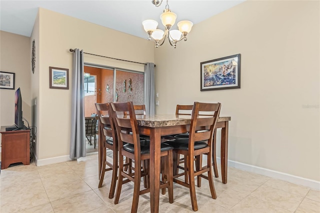 dining space featuring a chandelier and light tile floors