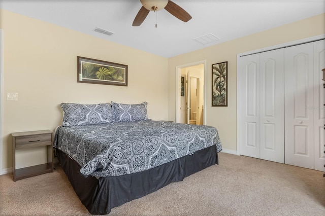 bedroom featuring light colored carpet, a closet, and ceiling fan