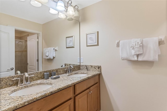 bathroom featuring a notable chandelier, dual vanity, and an enclosed shower