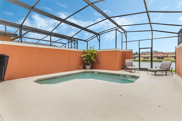 view of swimming pool with a patio area and a lanai