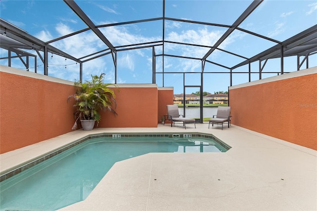 view of pool featuring glass enclosure and a patio area