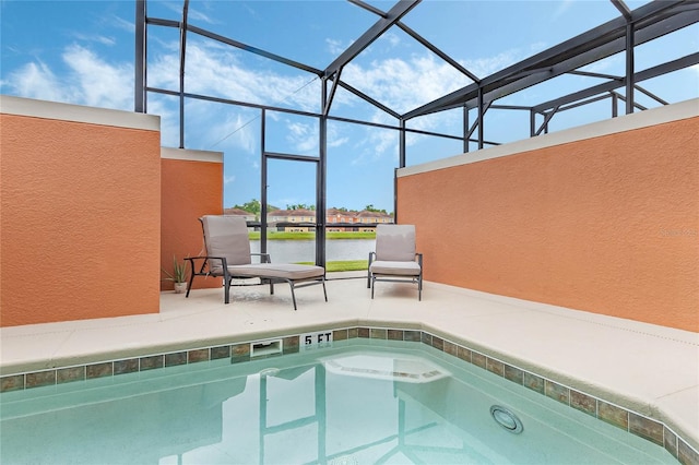 view of pool featuring a patio area and glass enclosure