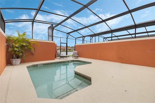 view of swimming pool featuring a patio and a lanai