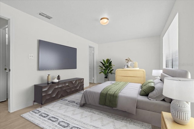 bedroom with light hardwood / wood-style floors