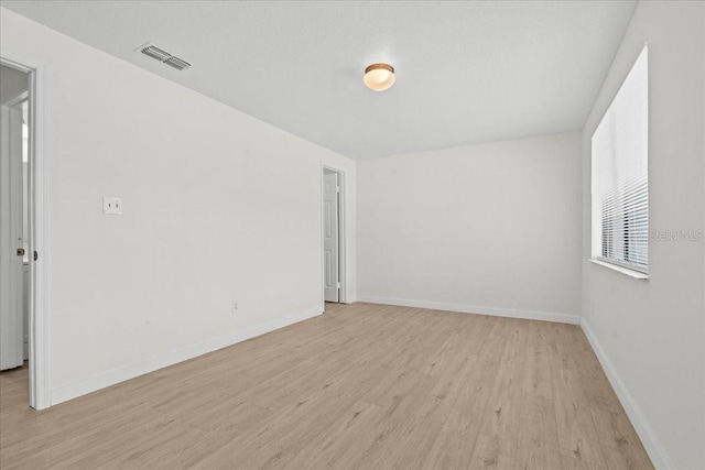 empty room with light hardwood / wood-style floors