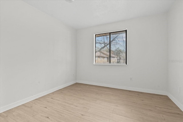 empty room with light hardwood / wood-style flooring