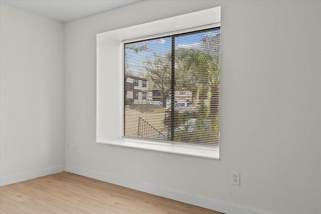 empty room with light hardwood / wood-style flooring