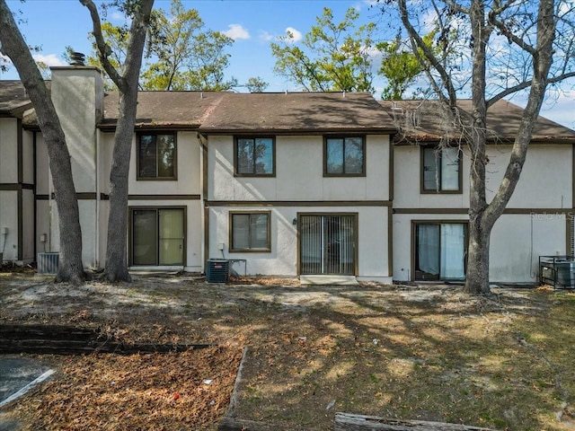 rear view of property with central AC