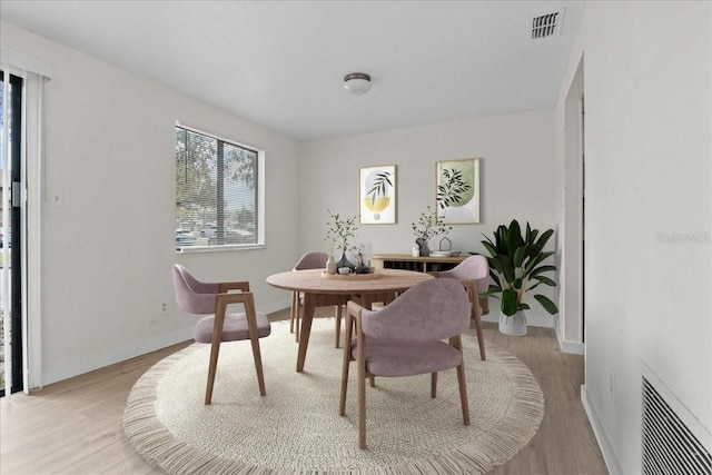 dining space featuring light wood-type flooring