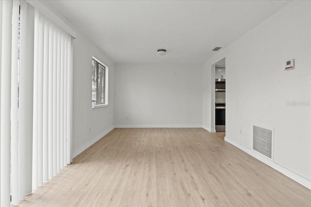 spare room with light wood-type flooring