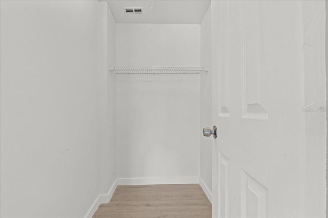 walk in closet featuring light hardwood / wood-style flooring