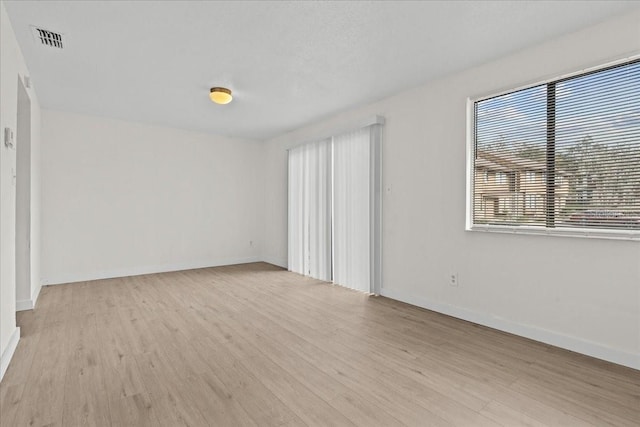 spare room with light wood-type flooring