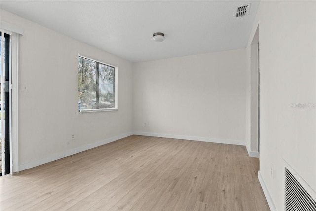 unfurnished room with light wood-type flooring