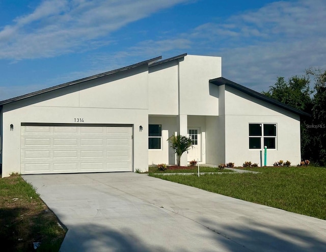 contemporary house with a front yard and a garage