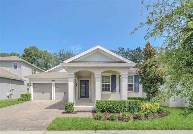 neoclassical home featuring a garage