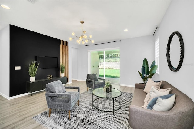 living room with a notable chandelier and hardwood / wood-style flooring