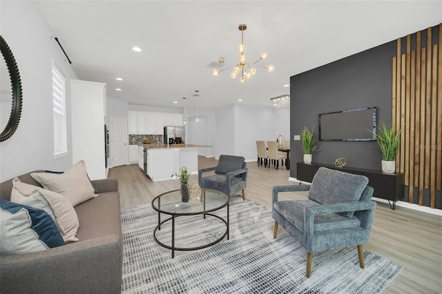 living room featuring light hardwood / wood-style floors and a notable chandelier