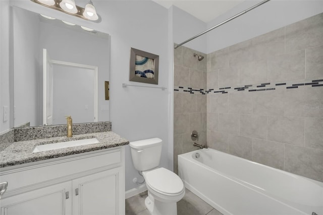 full bathroom featuring tiled shower / bath combo, vanity, toilet, and tile patterned floors