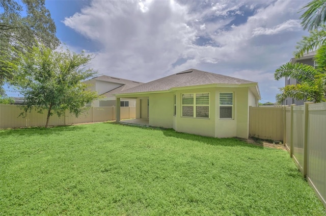 rear view of property with a lawn